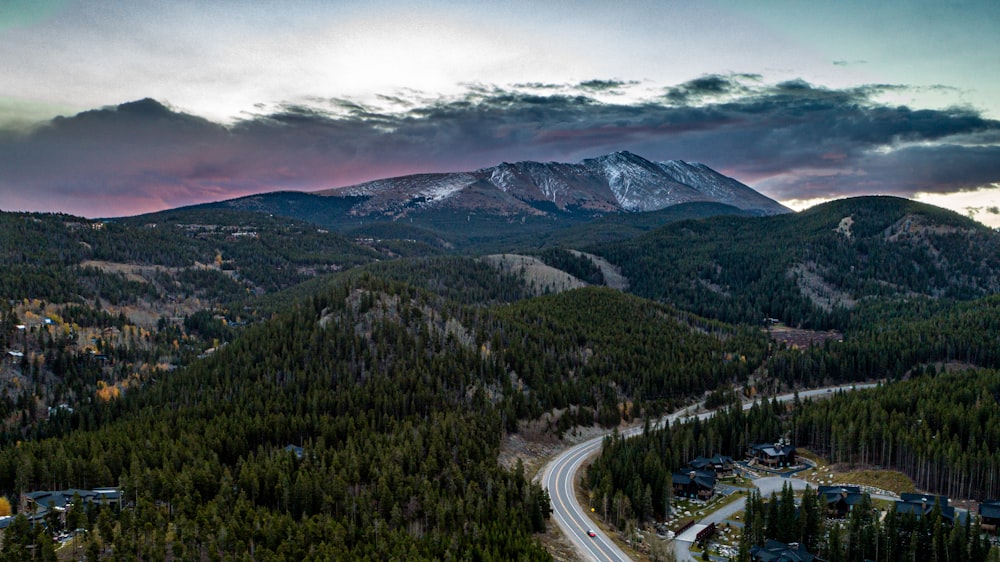 a scenic view of a mountain with a road in the foreground