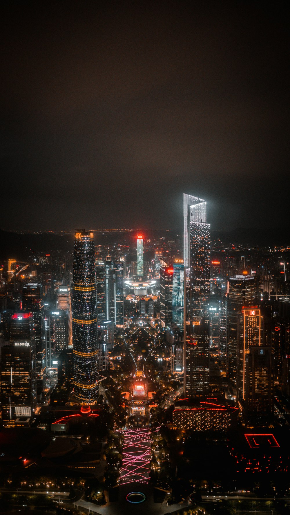 a view of a city at night from the top of a hill