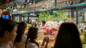 Bright and airy shop interior with rows of colorful cut flowers and bouquets.