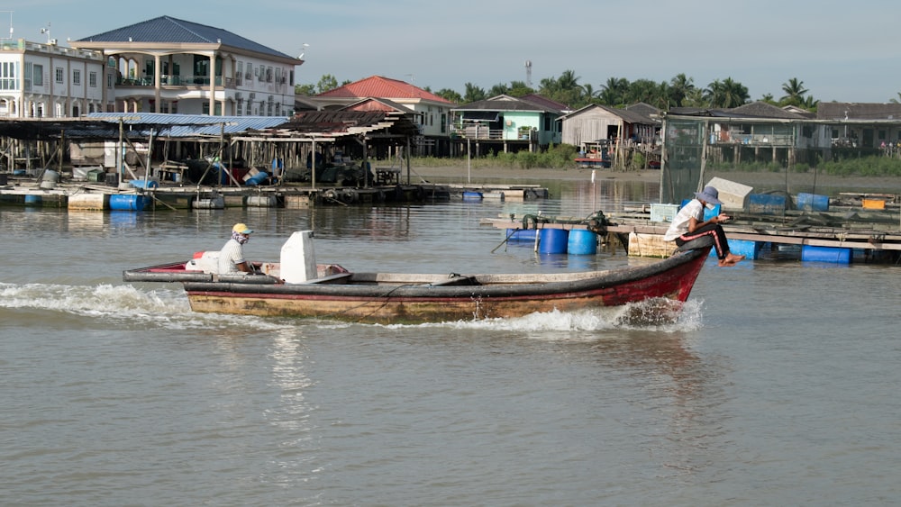 a man in a small boat on a body of water