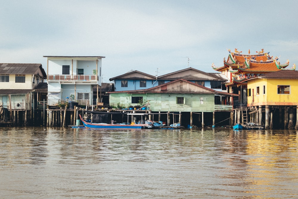 a group of houses sitting on top of a body of water