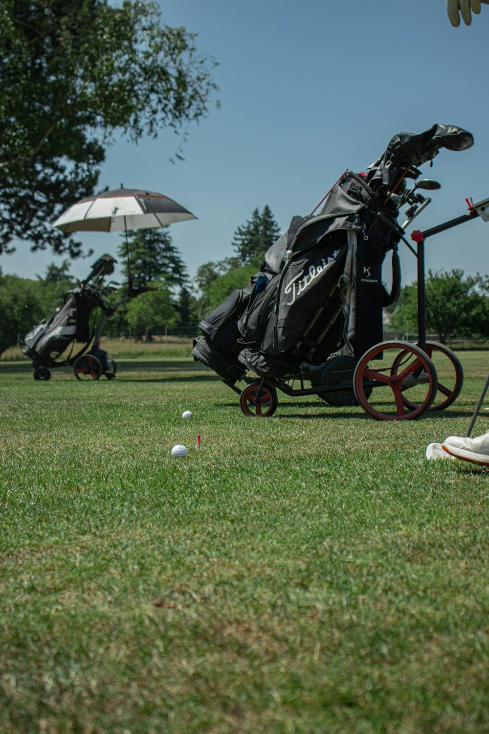 a golf cart with a golf bag and golf balls on the grass