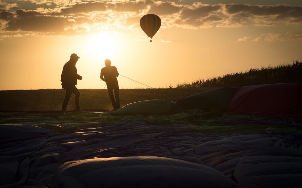 a couple of people standing on top of a field