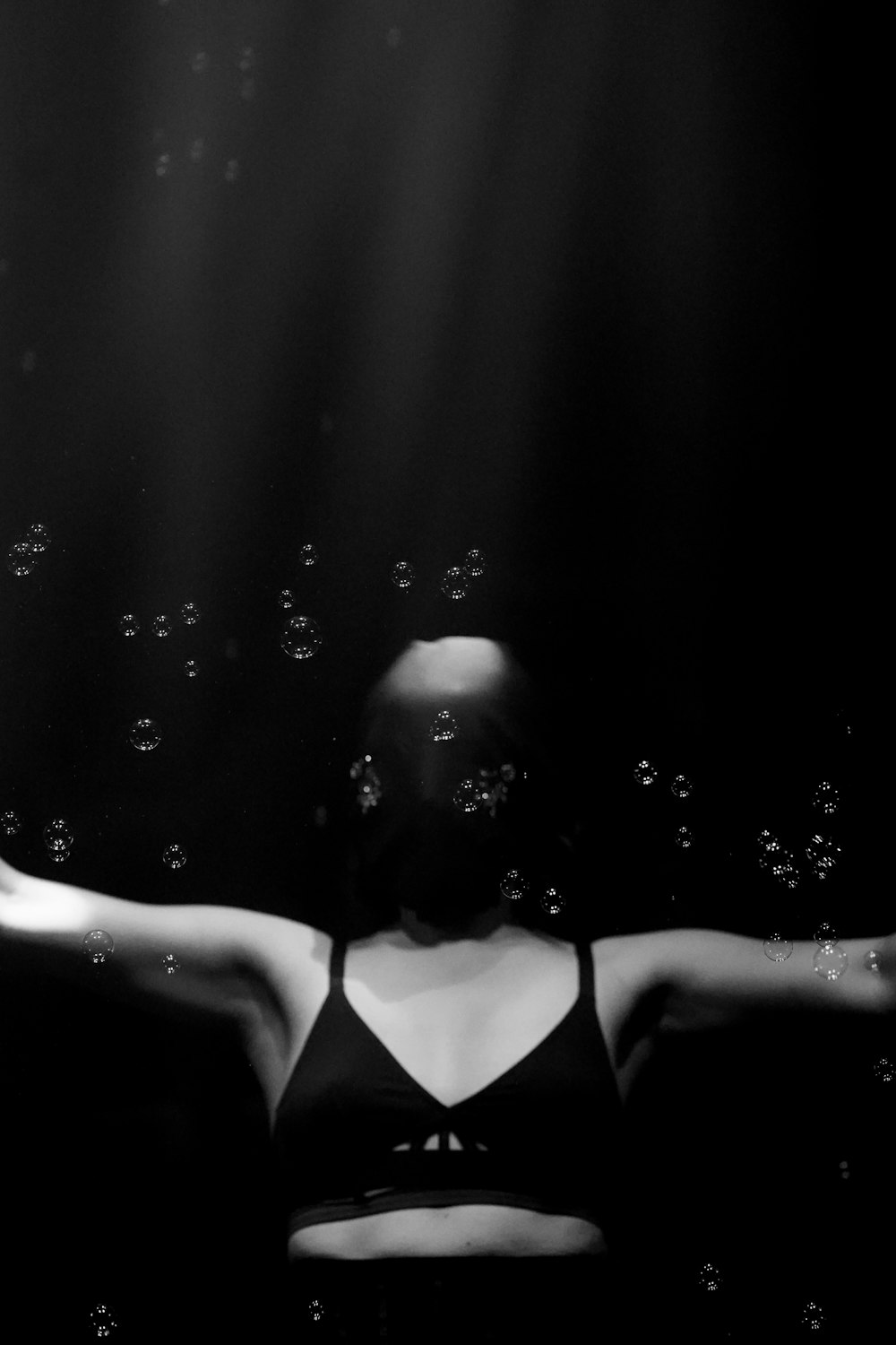 a black and white photo of a woman in a bathing suit