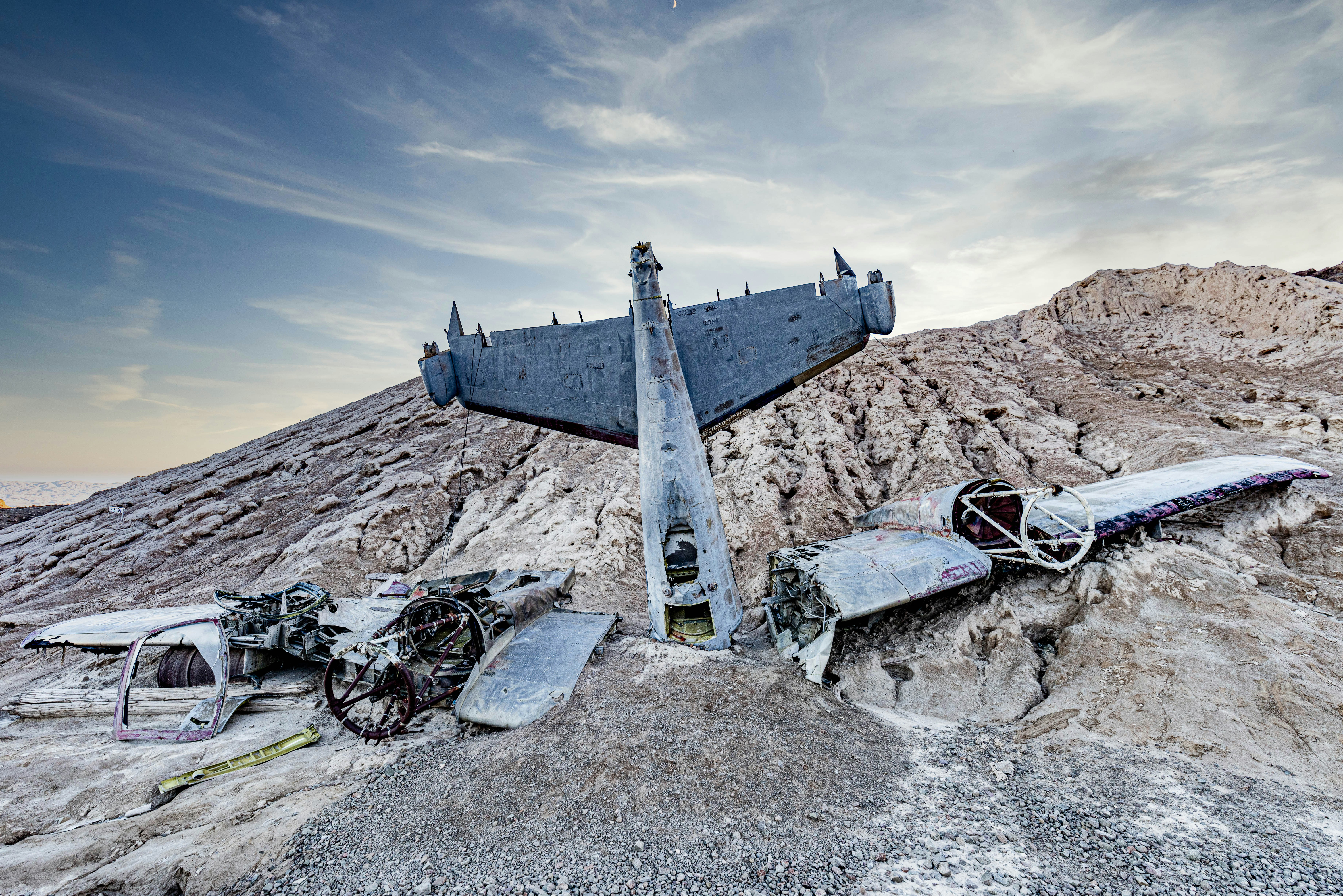a large airplane sitting on top of a rocky hillside