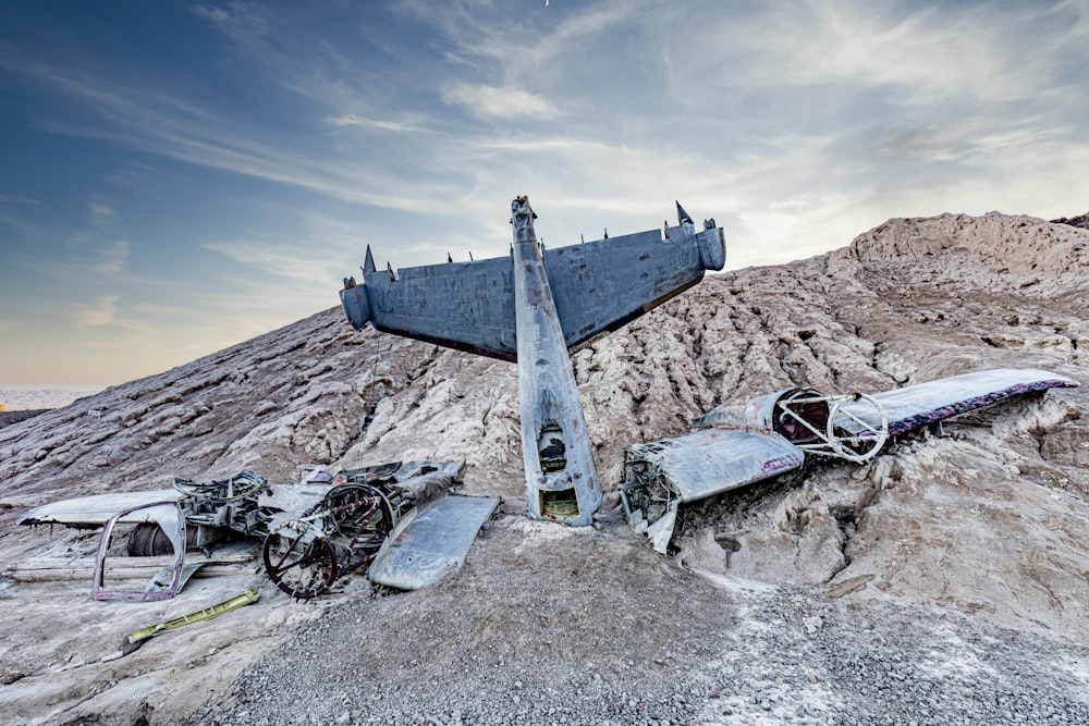 a large airplane sitting on top of a rocky hillside