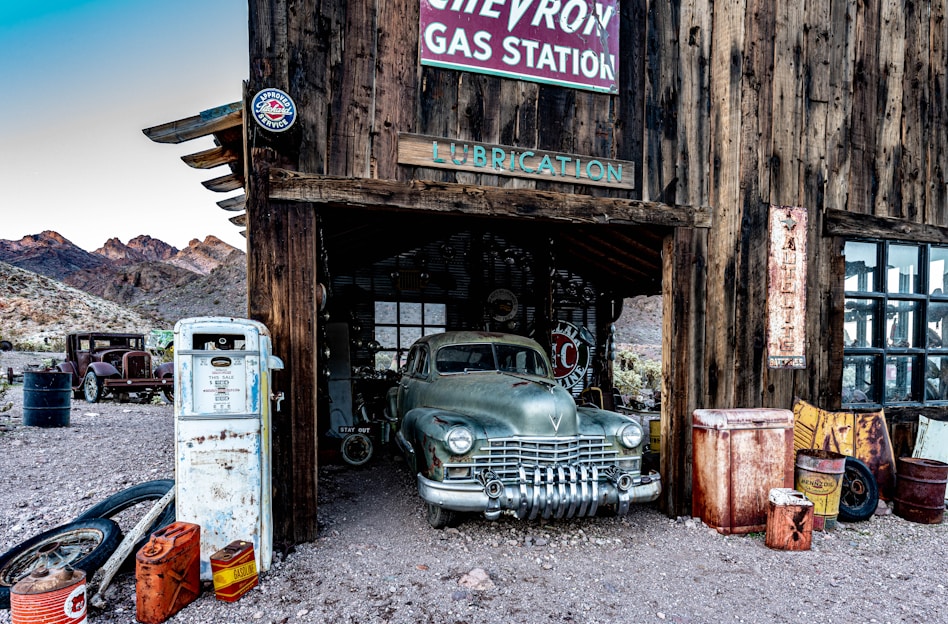 A vintage gas station with rustic signage and warm lighting.