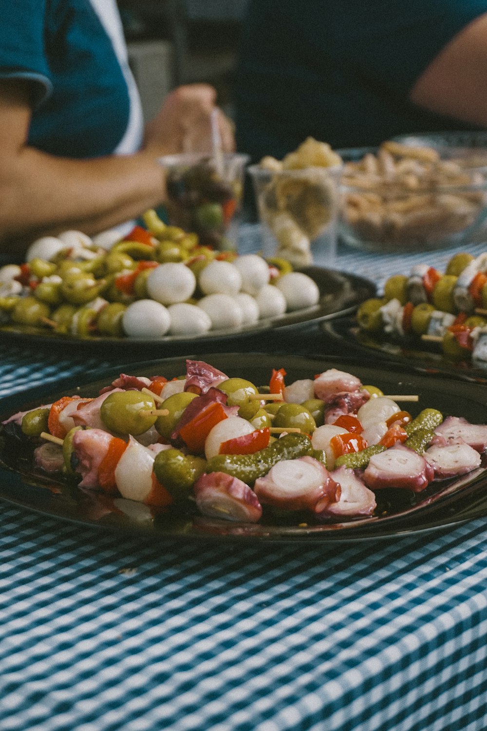 a table topped with plates of food covered in veggies