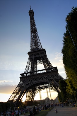 Traveler capturing the Eiffel Tower at sunset in Paris.