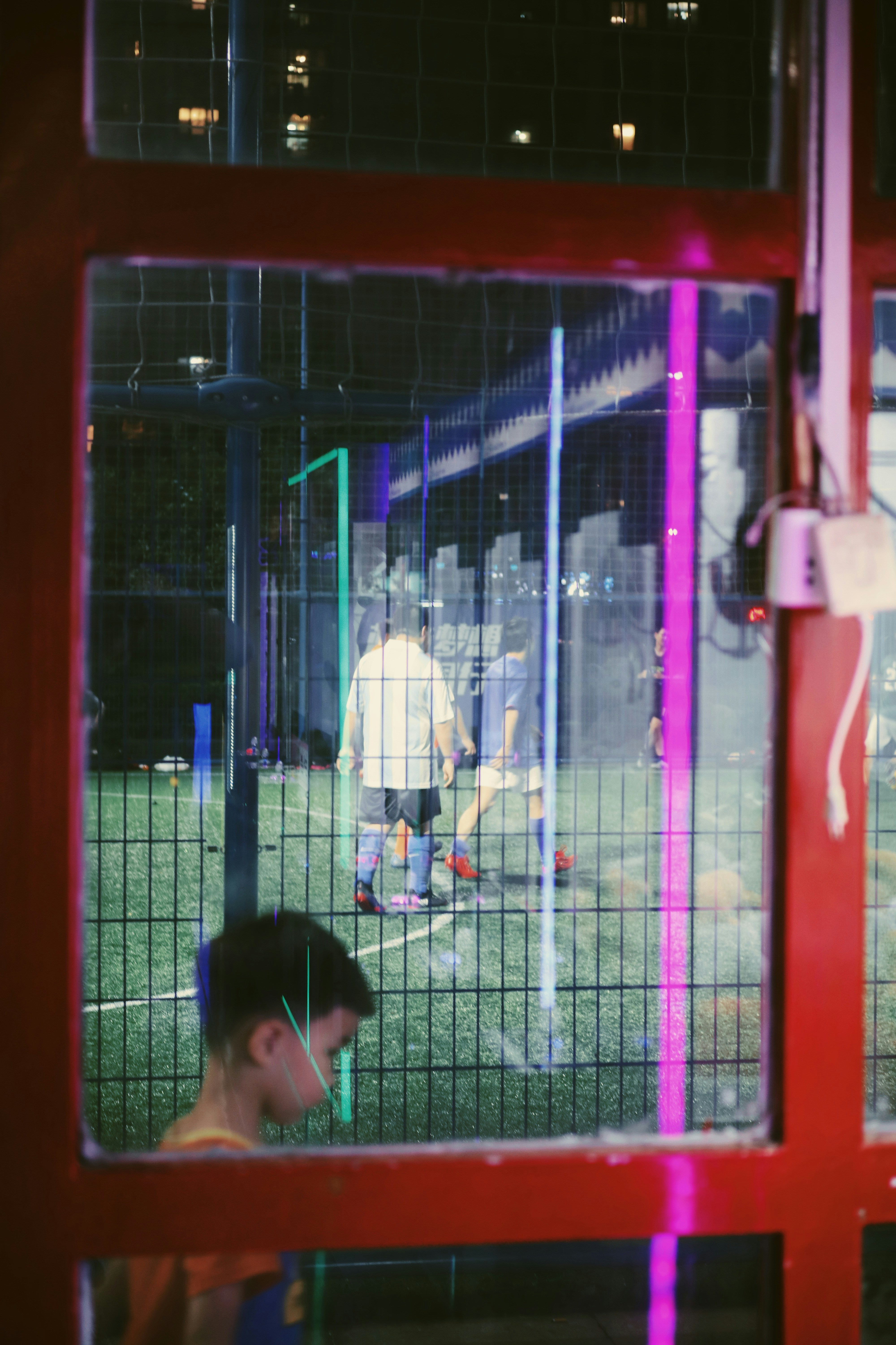 a man standing in front of a baseball cage