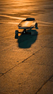 A pair of sleek skateboard bearings shining under natural light on a wooden surface.