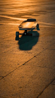 A pair of sleek skateboard bearings shining under natural light on a wooden surface.
