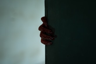A chilling close-up of a bloodied, realistic severed hand prop with intricate skin texture.