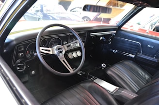 Interior view showing custom-installed performance gauges and bold checkered-flag accents inside a Camaro.
