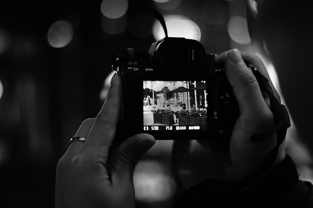 A photographer capturing a vibrant outdoor scene with a camera.