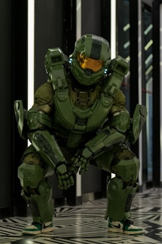 A mechanic in glowing green visor works on a damaged power armor suit amid a dimly lit space station.