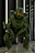 A customer wearing a detailed mechanized armor replica, standing confidently in a dark studio.