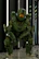A customer wearing a detailed mechanized armor replica, standing confidently in a dark studio.
