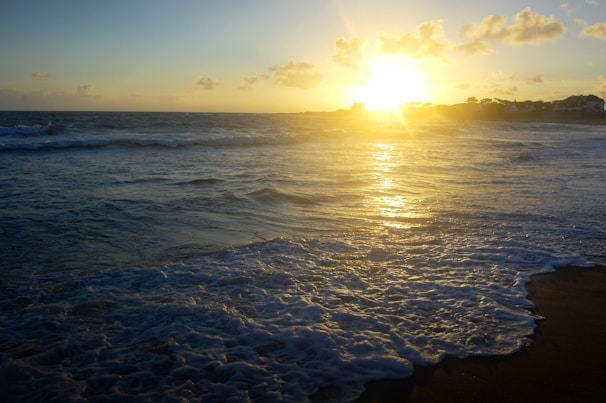 A beautiful sunset over a calm beach.