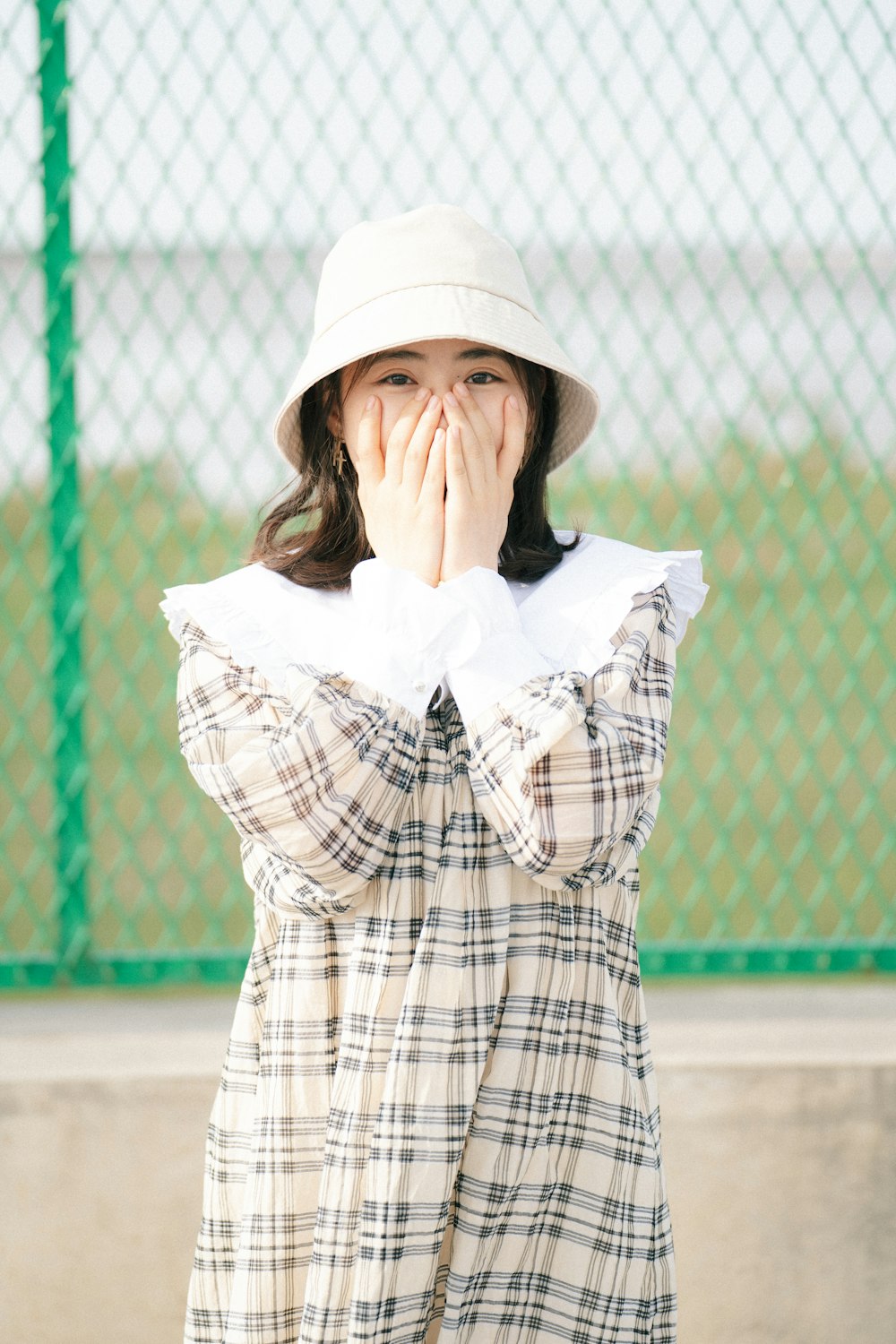 a woman covers her face with her hands