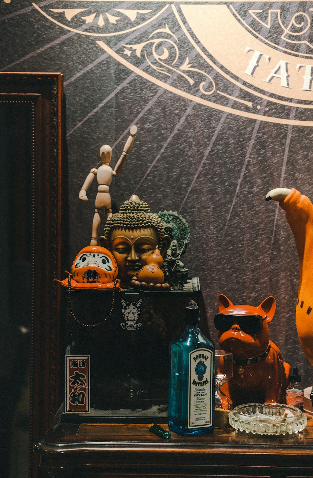 a shelf with a statue, figurines, and other items on it