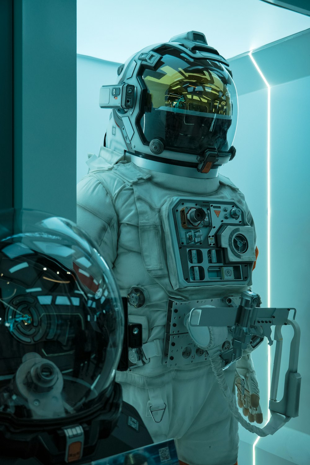 a man in a space suit standing next to a mirror