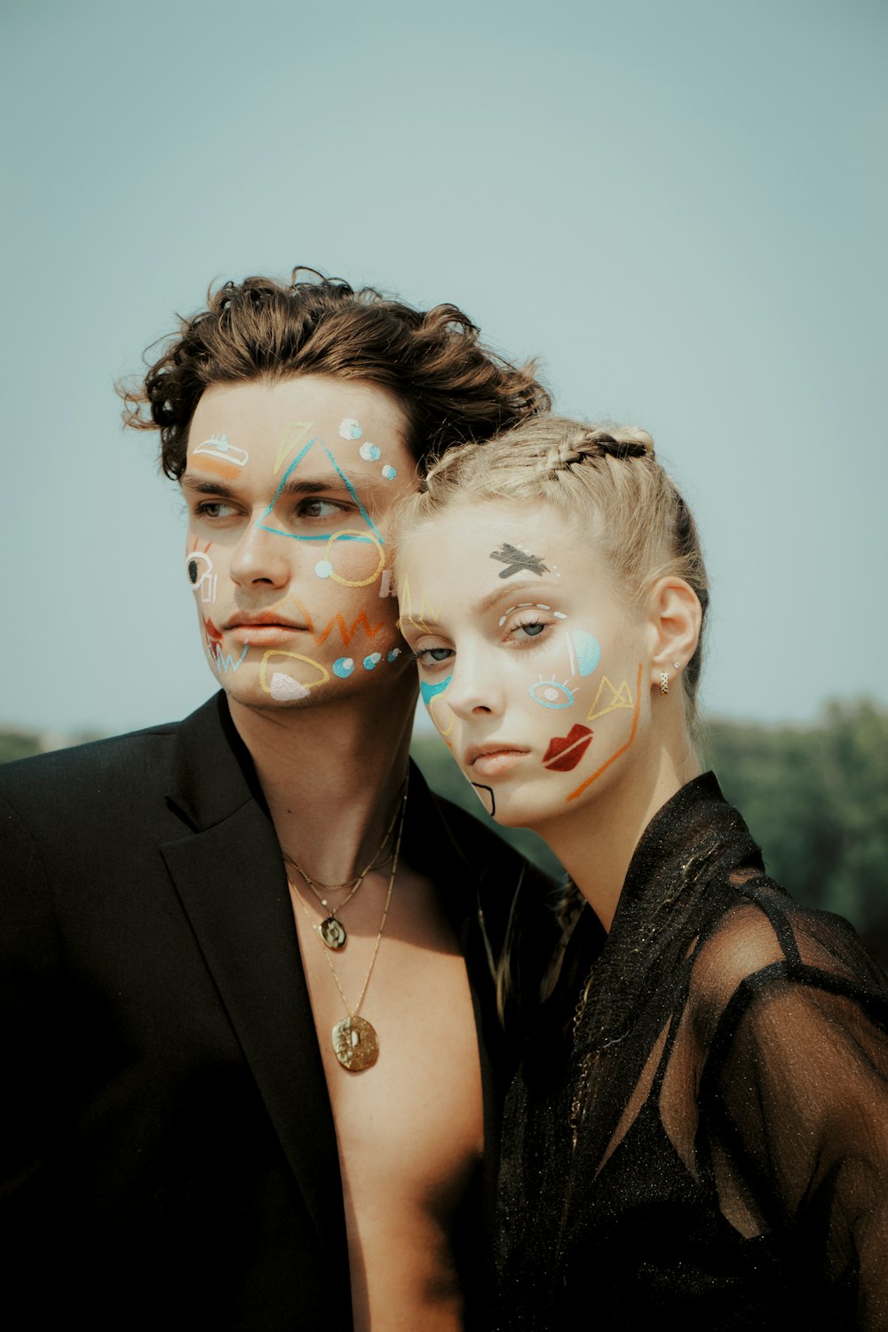 a man and a woman with painted faces