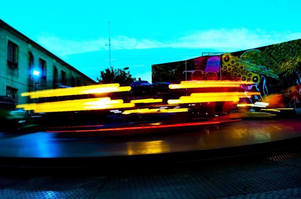 a blurry photo of a carnival ride at night