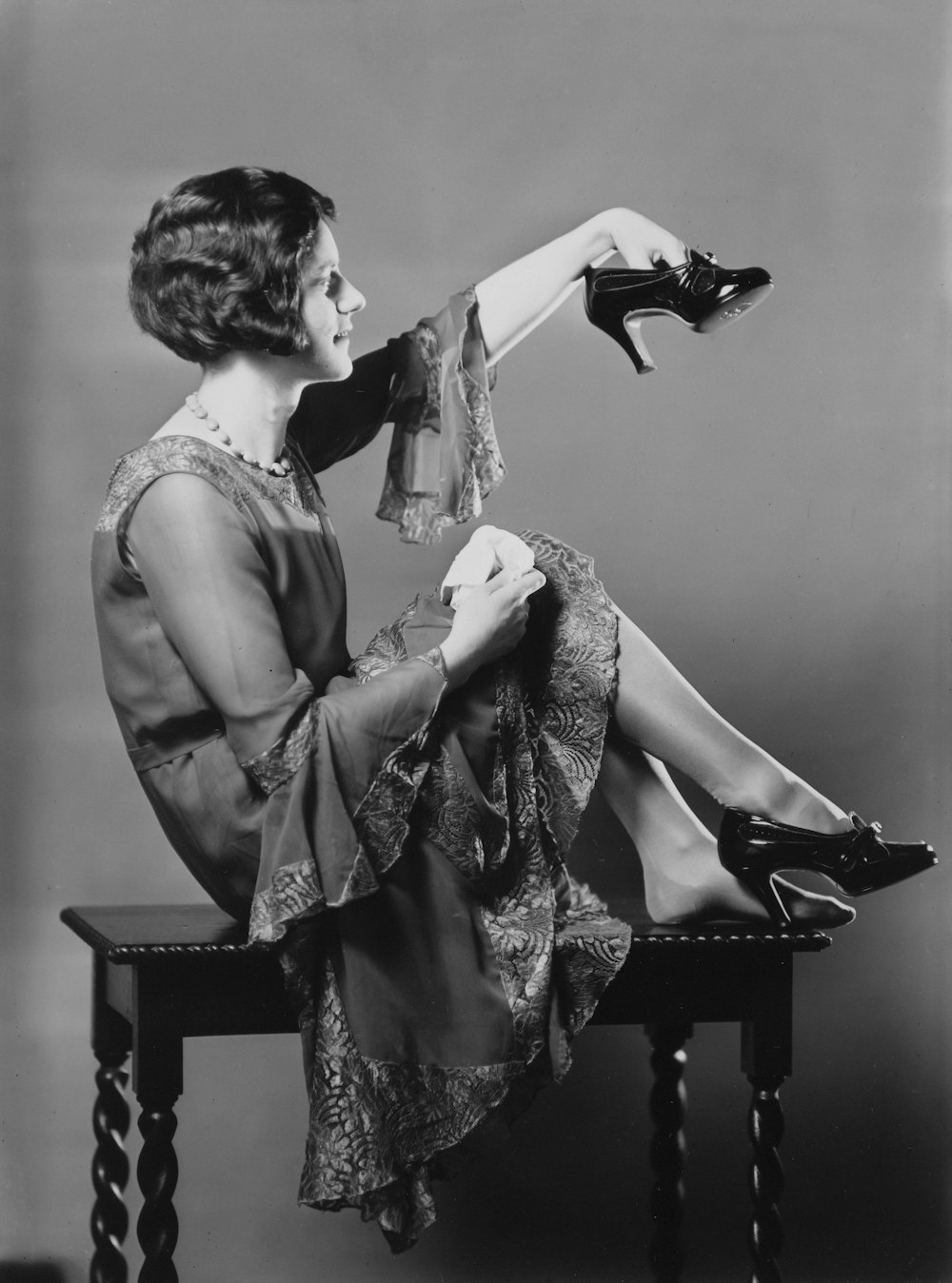 a woman sitting on top of a wooden table