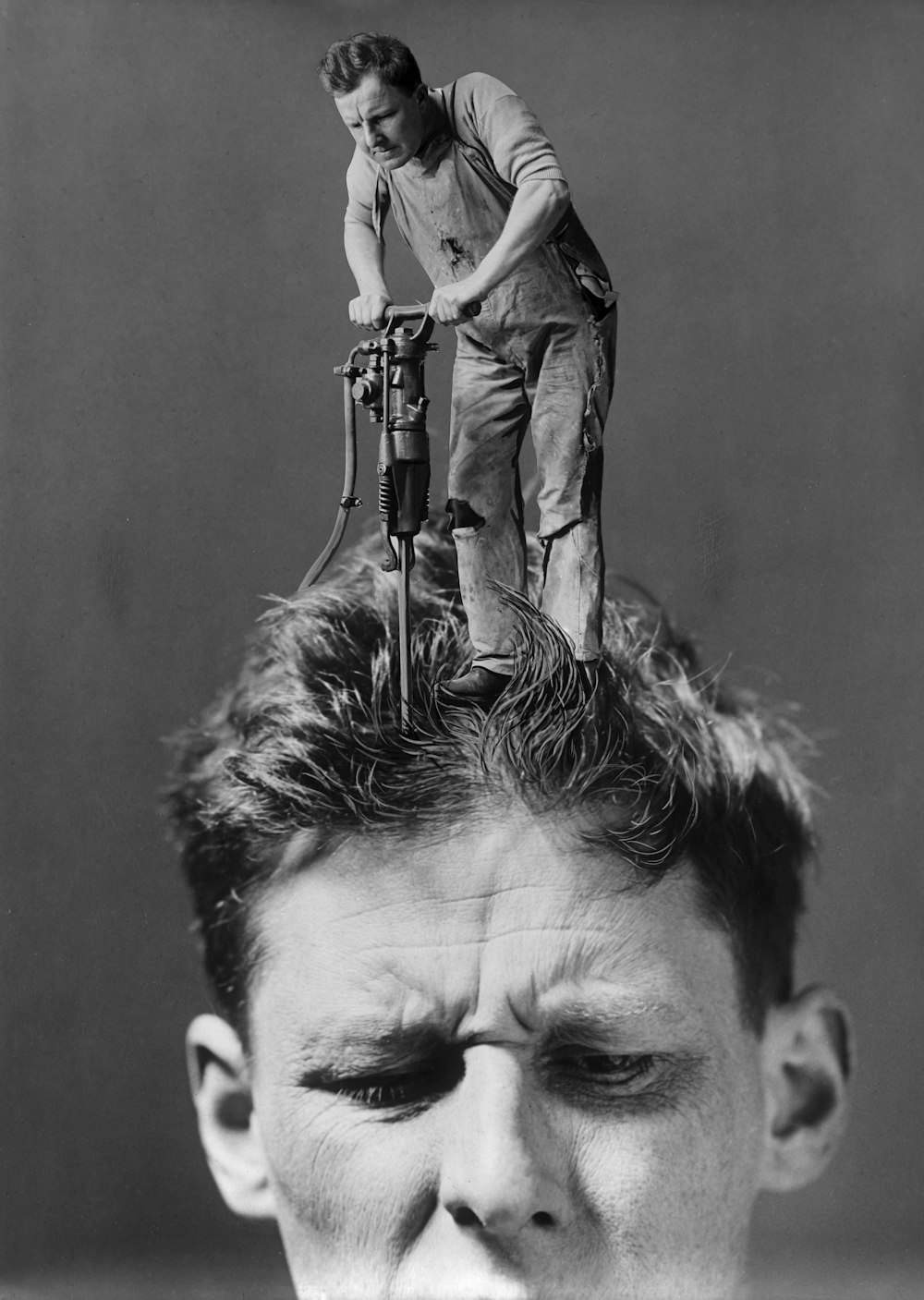 a man standing on top of another man's head