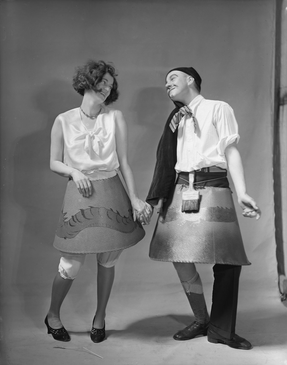 a man and a woman are dressed in a skirt