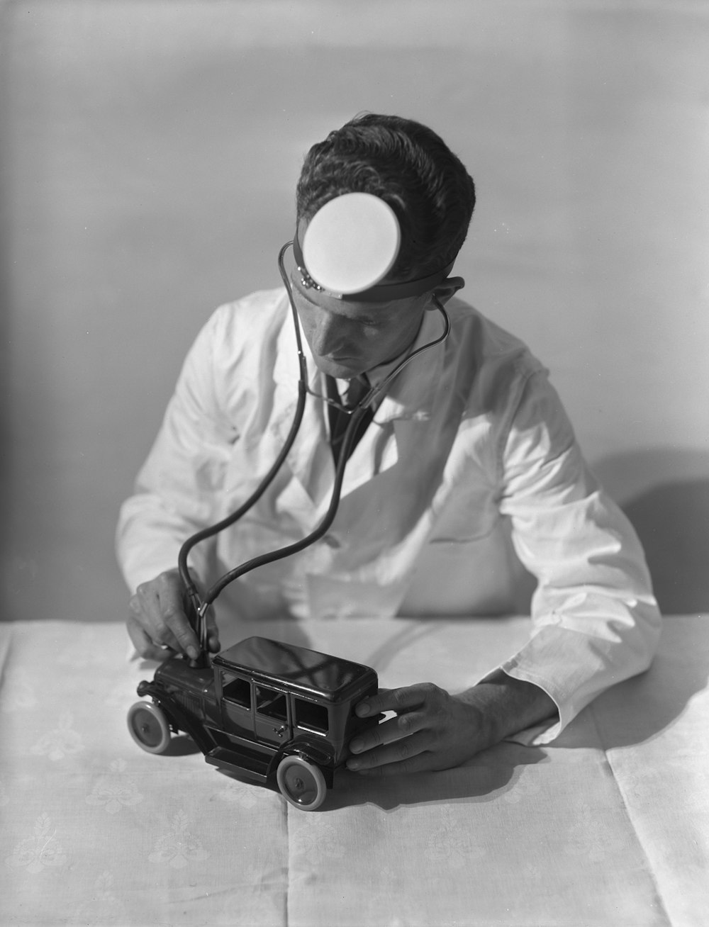 a black and white photo of a man with a stethoscope on his