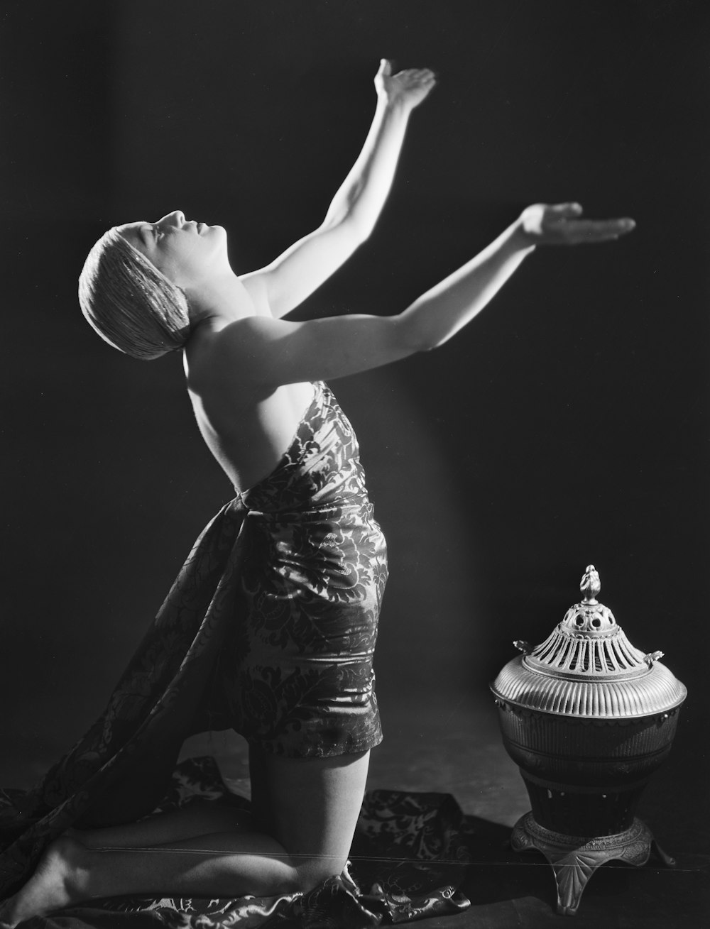 a black and white photo of a woman doing yoga