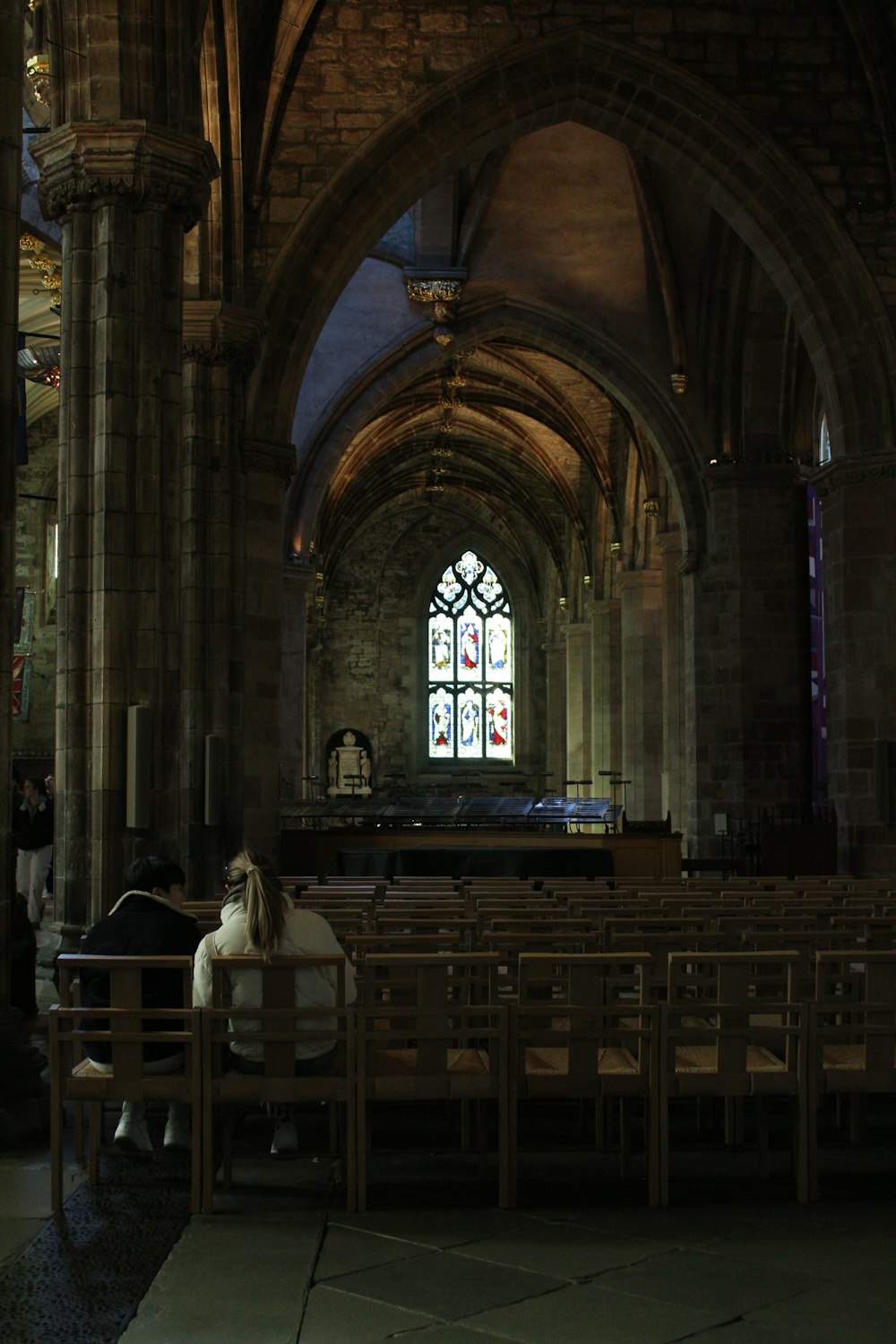 a person sitting on a bench in a church