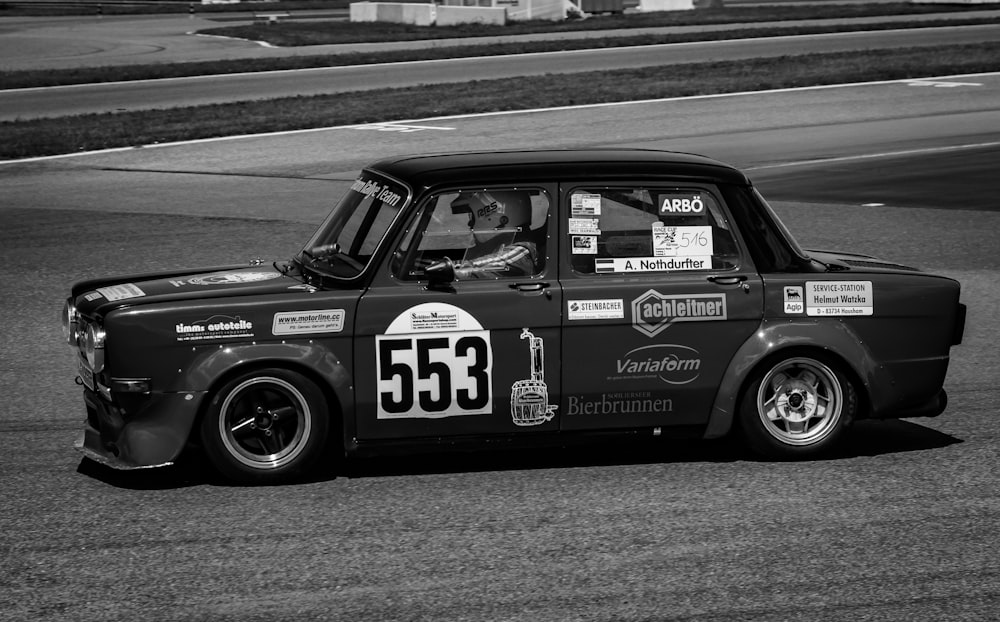 a black and white photo of a race car