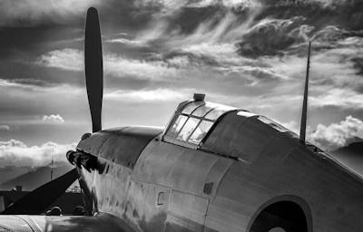 Elegant black and white poster featuring a vintage aircraft silhouette.