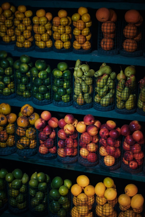 A vibrant display of ripe, colorful fresh fruits stacked neatly in baskets.