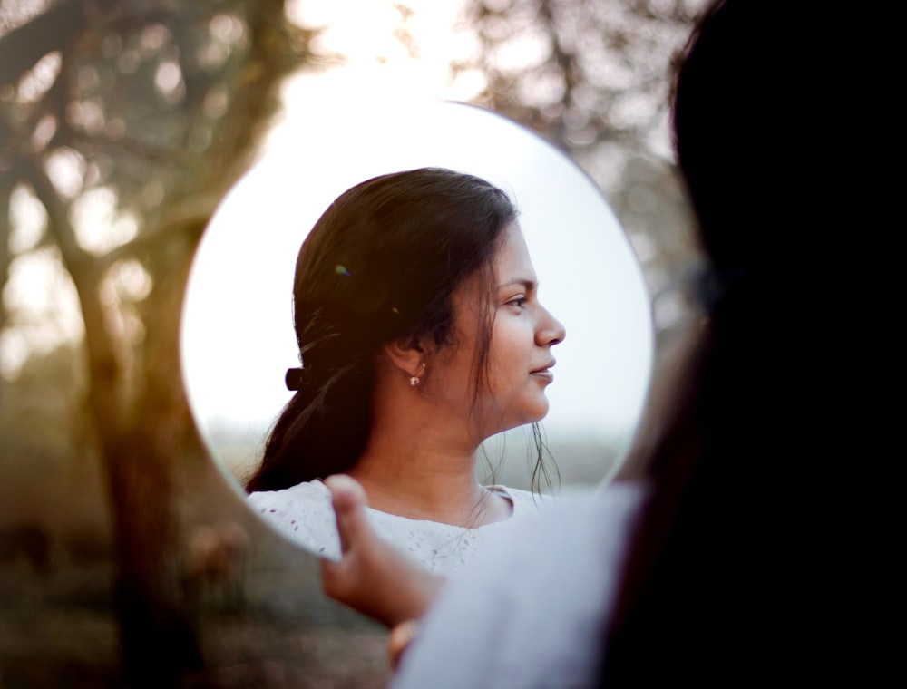 a woman looking at herself in a mirror