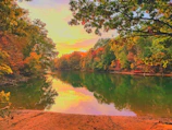A winding river reflecting the colorful hues of an autumn sunset.