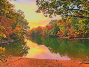 A winding river reflecting the colorful hues of an autumn sunset.
