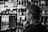 A security guard monitoring a retail store with a focused expression.