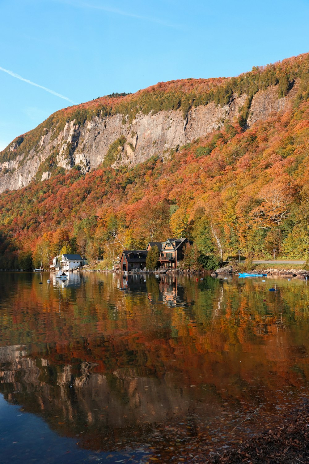 a body of water surrounded by a lush green hillside