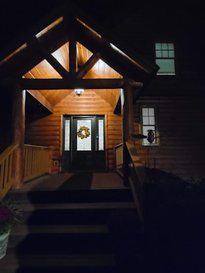 Cozy vacation home entrance with a welcoming door and warm lighting at sunset
