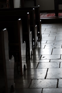 A serene synagogue interior with warm lighting and wooden benches, inviting prayer and reflection.