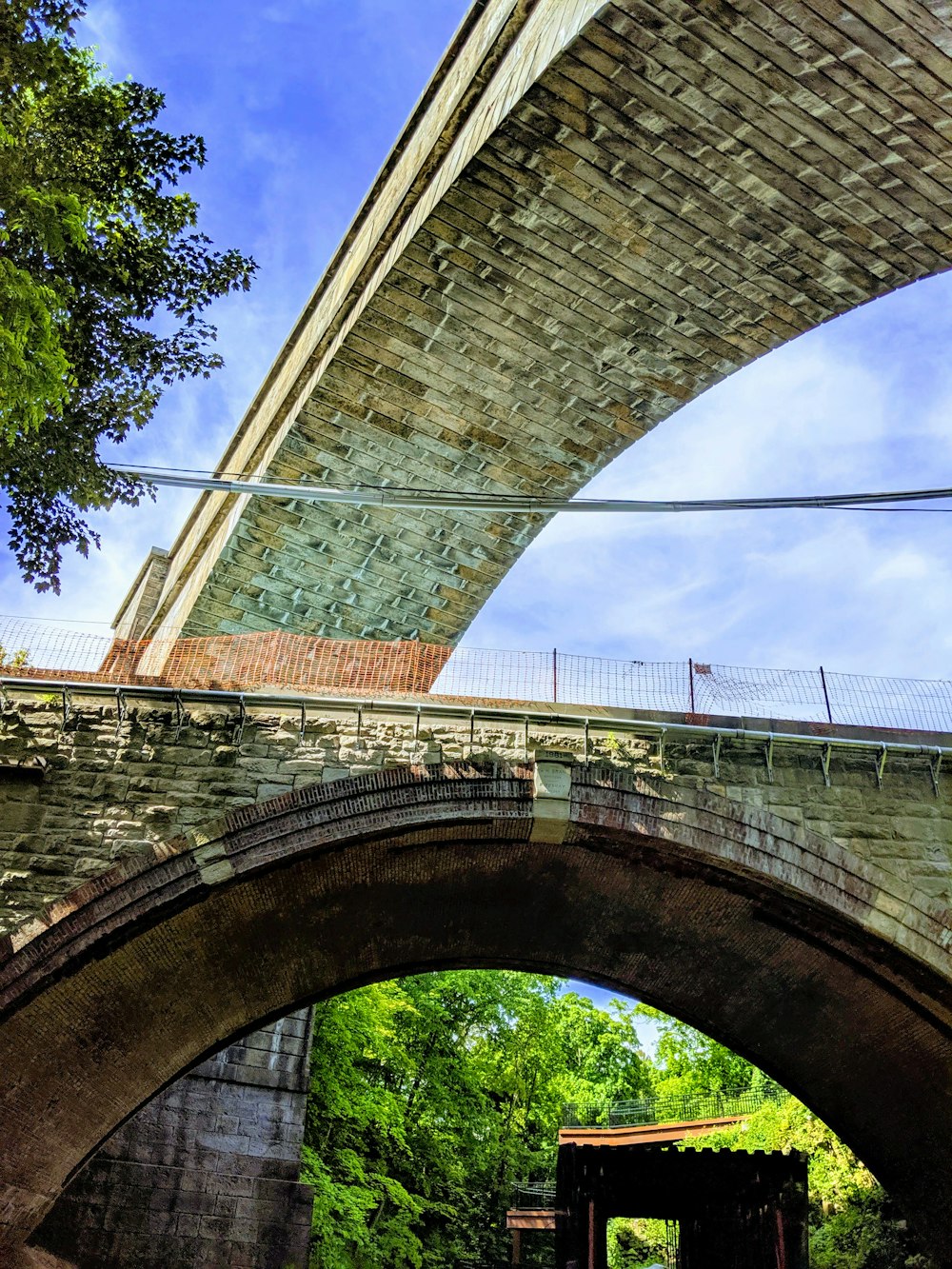 a bridge over a river with a train going under it