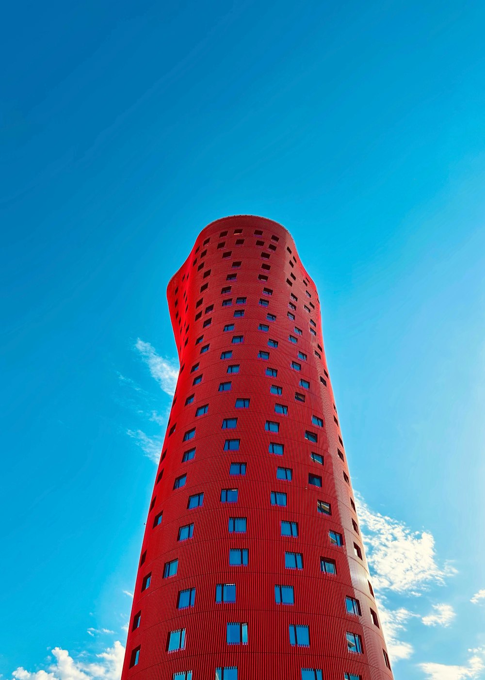 a tall red building with windows on the side of it