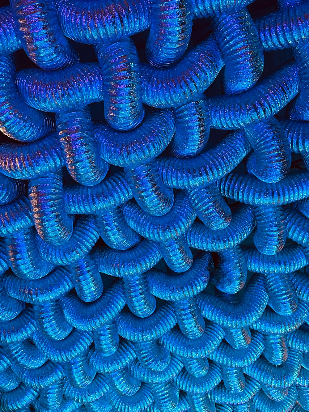 a bunch of blue spirals are stacked together