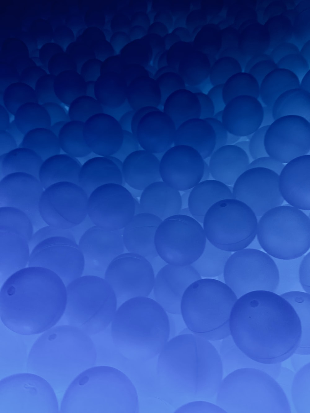 a group of blue balls floating in the air