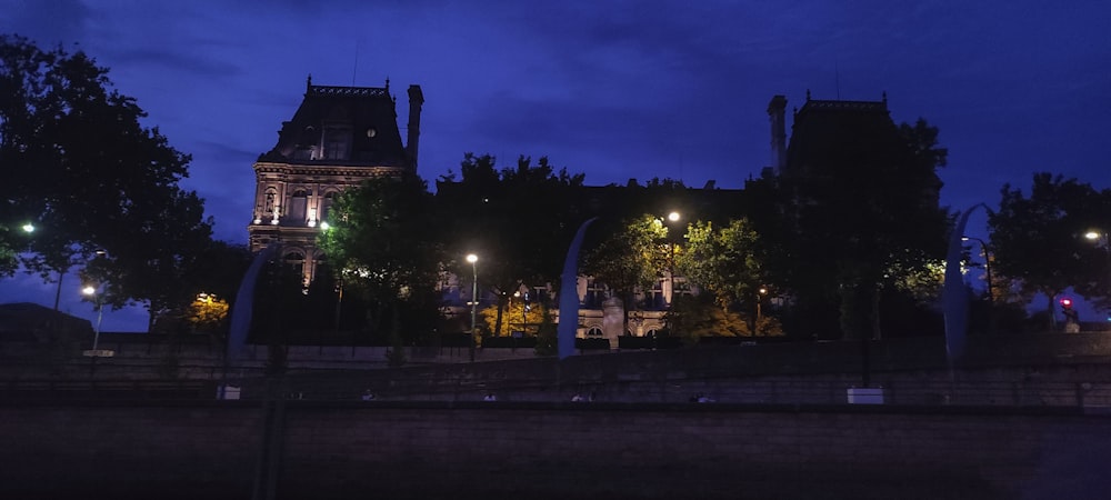 a building with a clock tower lit up at night