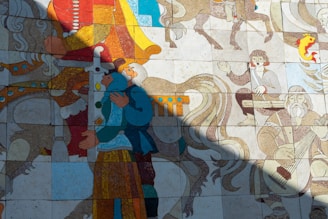 A colorful mosaic features figures engaged in various activities, including a person playing a stringed instrument and another riding a horse. The mosaic appears to tell a story with intricate details and vibrant hues, blending historical and mythical elements.